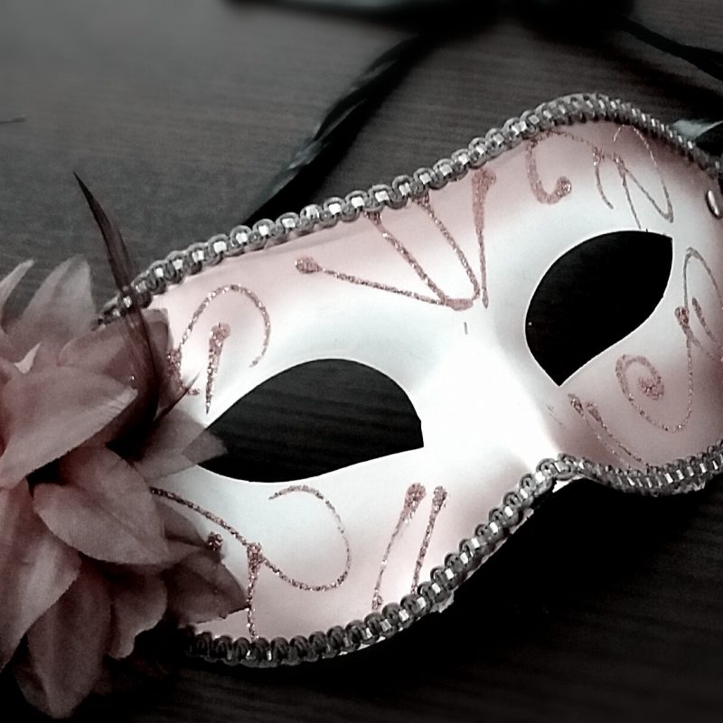Eye mask with eyes cut out decorated with patterns on a table